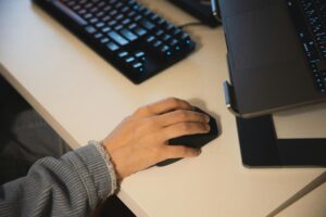 Hand on computer mouse.