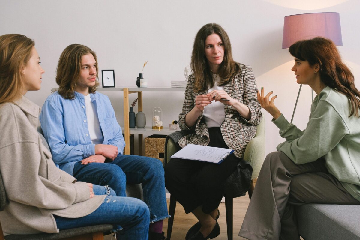 Adult with students having a discussion